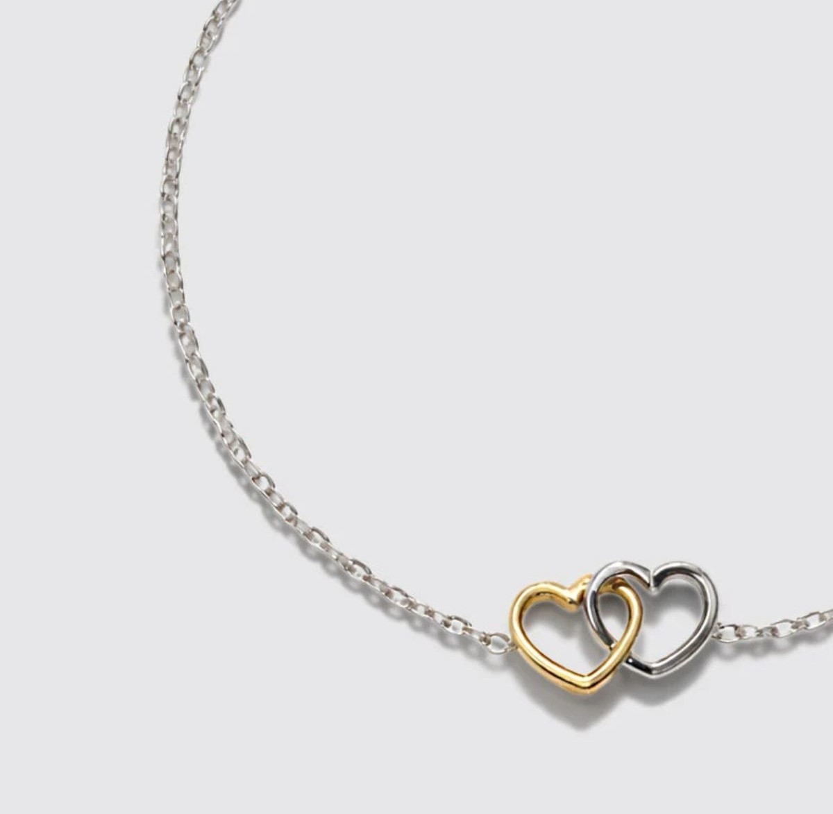 Bracelet argenté en acier inoxydable avec cœurs bicolores Bizou